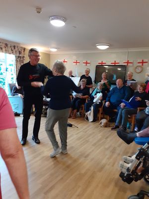 Residents at Coverage Care's Greenfield's home in Whitchurch enjoying singing with the Whitchurch Singers
