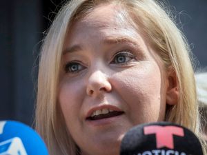 Close-up of Virginia Giuffre speaking to reporters