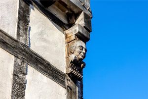 The heads of the craftsmen who renovated the home have been carved into the exterior woodwork of the house.