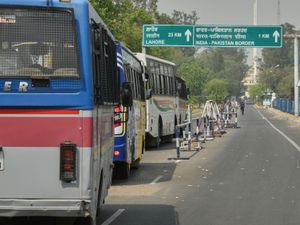 Buses carrying Pakistan nationals from India wait to cross over at the Attari-Wagah border between India and Pakistan