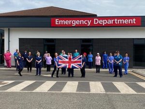 NHS staff at Princess Royal Hospital in Telford hold up the Union Jack