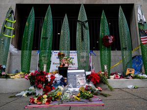 Supporting image for story: Man charged in National Guard shooting pleads not guilty from hospital bed