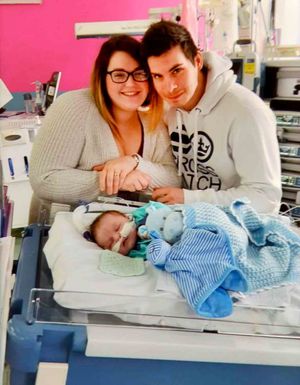 Charlie's parents with him at hospital. 