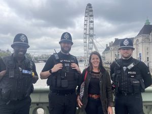 Jenny standing in the queue to see The Queen with police officers