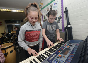 Making music on the keyboards at the Fun Club Hub