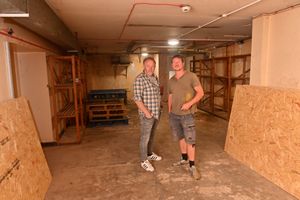 Andy Evans and Nicc Bennett in the room they hope will eventually become a pub games area