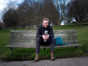 Filmmaker Will Shears sitting on a bench