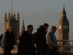 Commuters cross Waterloo Bridge in London