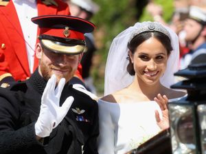 Harry and Meghan ride in an open-topped carriage through Windsor Castle after their wedding in St George’s Chapel.