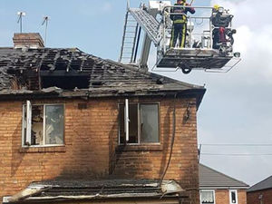 Supporting image for story: Firefighters rescued after platform stuck in mid-air during house blaze