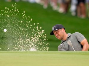 Xander Schauffele plays out of a bunker