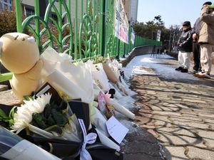 People mourn the death of a pupil allegedly stabbed to death by a teacher outside an elementary school in Daejeon, South Korea