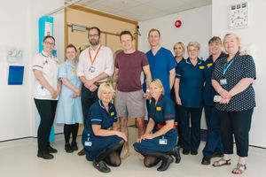 Patient Phil Holdcroft is pictured up on his feet with his consultant Prof Geraint Thomas, alongside members of the multi-disciplinary team who provided his care, just hours after undergoing hip replacement surgery.