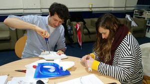 Volunteers repair an iron at a repair cafe