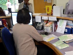 A receptionist sorts prescriptions at the Temple Fortune Health Centre GP Practice near Golders Green, London