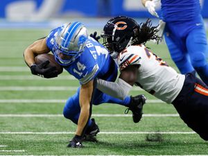 Detroit Lions wide receiver Amon-Ra St Brown is tackled by Chicago Bears cornerback Terell Smith