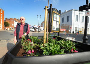 John Rosser, with one of the planters he helped pay for, in memory of his friend, at Castle Square, Ludlow