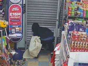 Supporting image for story: Moment West Midlands armed robber gets trapped inside shop he tried to rob by quick-thinking shopkeeper