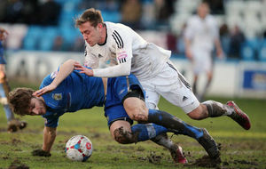 Adam Cowen of Stockport County and Adam Farrell of AFC Telford United