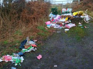 Supporting image for story: 'The tree still had the decorations on!' Christmas tree and wrapping paper fly tipped in country lane near Market Drayton