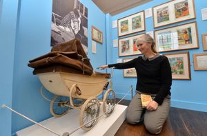 SHREW COPYRIGHT SHROPSHIRE STAR STEVE LEATH 10/03/2022..Pic in Shrewsbury Museum and Art Gallery of Helen Day, and an exhibition she has put together to celebrate the Ladybird Book Series. She lives in Hertfordshire but used to live in Finchfield, Wolverhampton. The Pram as used in the Peter & Jane Books..