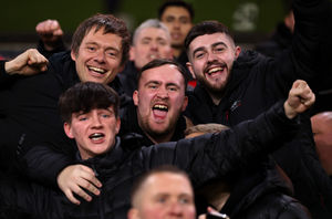 Luke Littler celebrates Manchester United's victory in the Premier League match between Wolverhampton Wanderers and Manchester United at Molineux