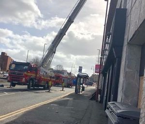 Firefighters used a hydraulic platform to check the roof. Photo: G and T Properties