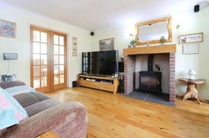 The bright front lounge features a bay window and opens through to the dining space, creating a light and welcoming living area