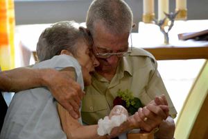 The couple hold one another during the emotional ceremony.