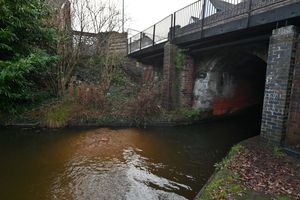Silt and debris can be seen near the entrance of the tunnel