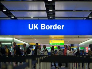 A general view of passengers waiting at the UK border at an airport