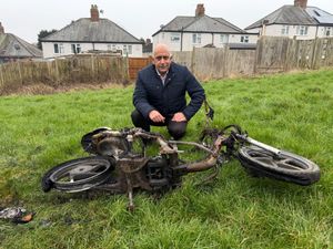 Cllr Shaukat Ali with a burned out motorbike in Brewery Fields. Picture Cllr Shaukat Ali free for LDRS use