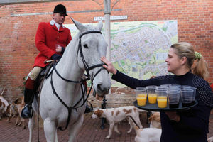 The Burton Hotel owner Jana Hyde greets one of the horses as she serves hunt members with drinks. Image by Andy Compton
