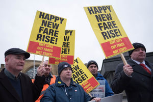 Campaigners protest against rail fare increases outside King's Cross station in London.