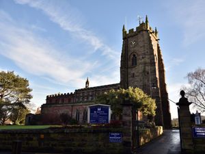 Supporting image for story: Part of churchyard cordoned off after brick wall collapses on steep bank