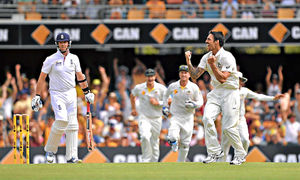 Australia's Mitchell Johnson (right)celebrates taking the wicket of England's Graeme Swann (left) for 0