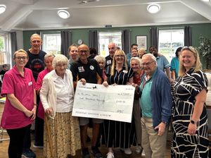 Robert Ratcliffe of OCWFC presents a £1,000 cheque to Wendy Clifton Home Manager of Pelsall Hall, residents and Pelsall Hall team