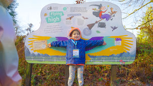 A child comparing their wing span on the new Room on the Broom trail.