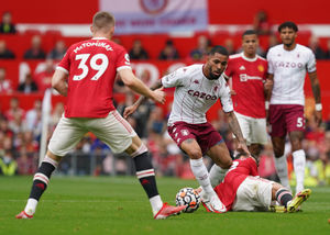 Aston Villa's Douglas Luiz (centre) takes on Manchester United's Scott McTominay