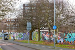 Graffiti has been sprayed along the length of the boarding
