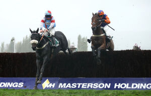 Saint Calvados ridden by Gavin Sheehan (left) clears the last before winning the Randox Health Handicap Chase during day two of The Showcase Meeting at Cheltenham Racecourse