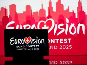 The 2025 Eurovision Song Contest logo is seen displayed on a tablet
