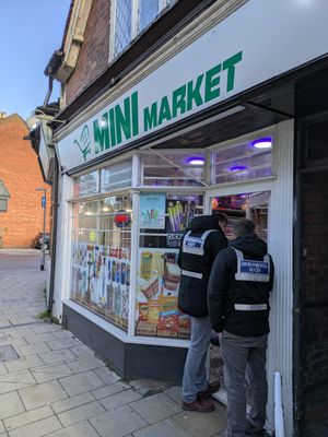Officers carrying out the enforcement operation at Mini Market, St John Street, Lichfield.