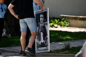 A mourner holding a photo of Andre Silva at the wake of Diogo Jota being held at Sao Cosme Chapel in the town of Gondomar near Porto