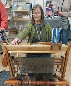 Rosie Green from SAORImor demonstrates weaving at Wonderwool Wales