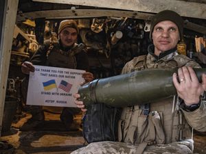 Soldiers of Ukraine’s 5th brigade hold a poster thanking for the US for support