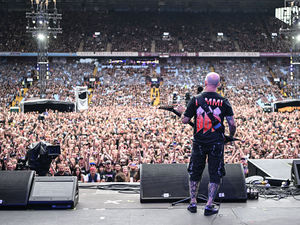Member of US rock band Anthrax, Scott Ian plays to the crowd as a support act, during British rock band Black Sabbath's "Back to The Beginning" concert, Ozzy Osbourne's final ever gig as Black Sabbath's frontman at Villa Park in Birmingham, central England on July 5, 2025