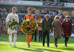 Wolves players Liam Cooper and Danny Batth, with Mr Matthews' son Nathan, wife Sharon, and daughter Jade