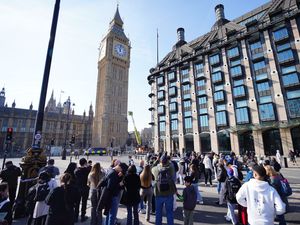 People watch on as the man perched on the clock tower of Big Ben