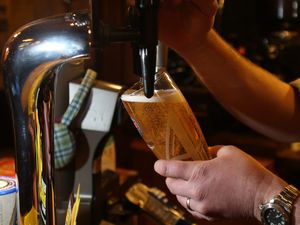 A pint of lager being pulled in a pub